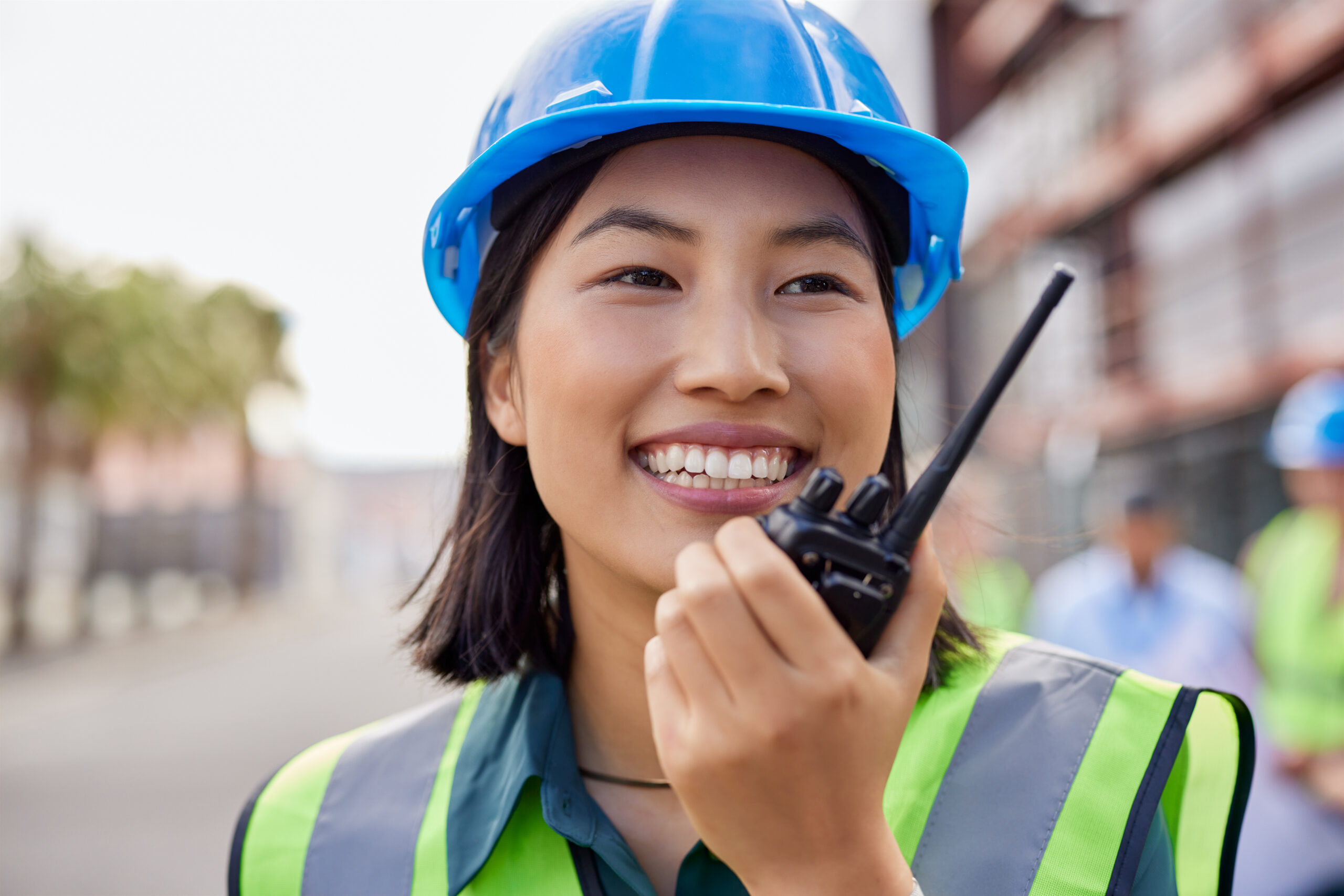 Chinese construction worker using walkie talkie at work Shaffer Communications
