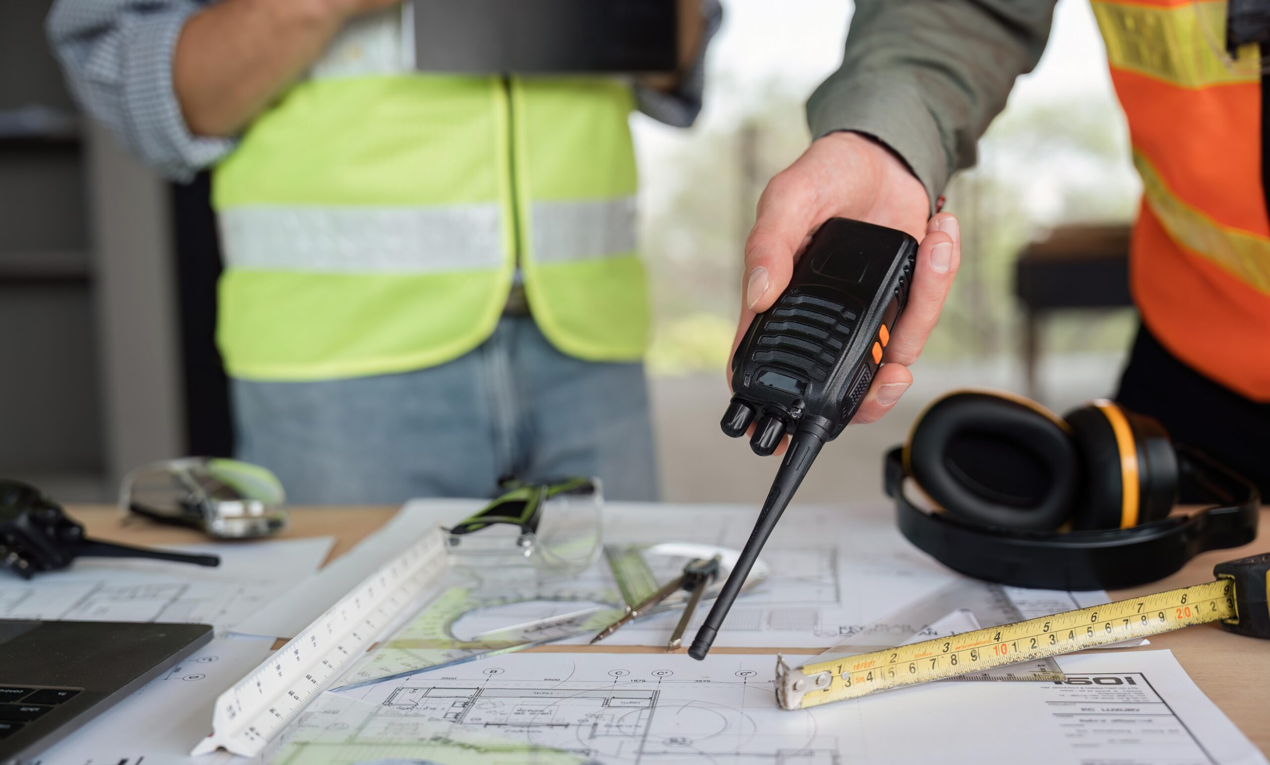male engineer holding walkie talkie and civil engineer with working together inspection housing estate project at the construction site Radio Accessories